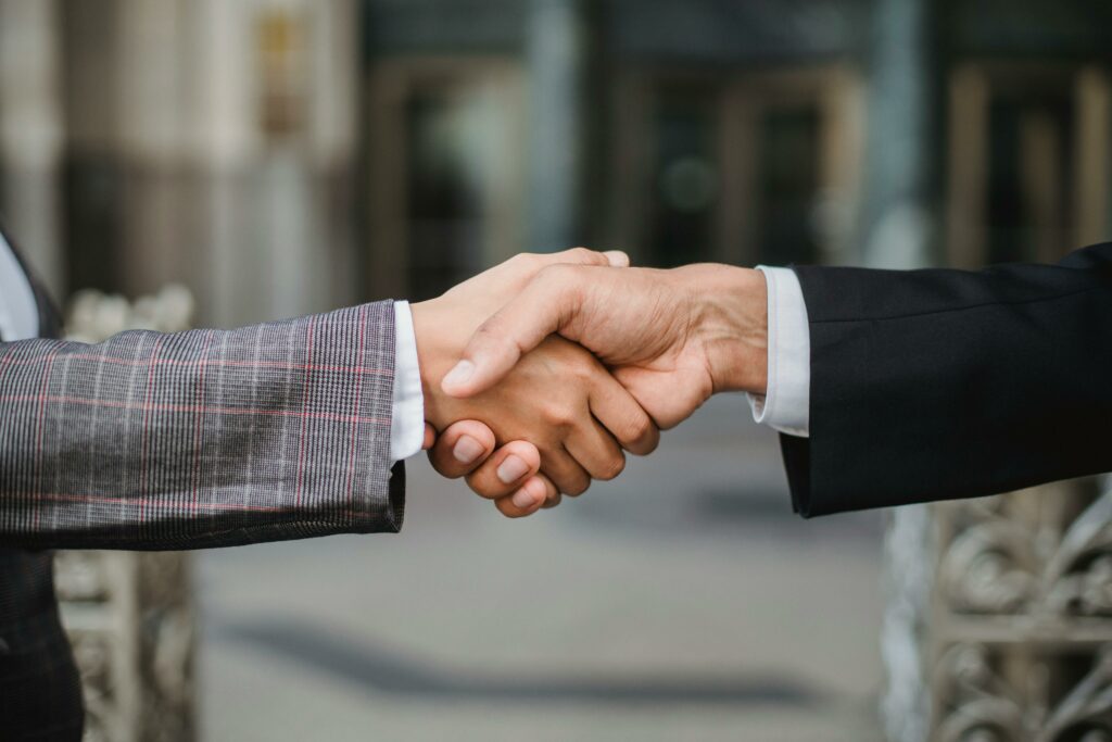 pexels photo 4963437 4963437 A close-up of two businesspeople shaking hands, symbolizing cooperation and partnership.